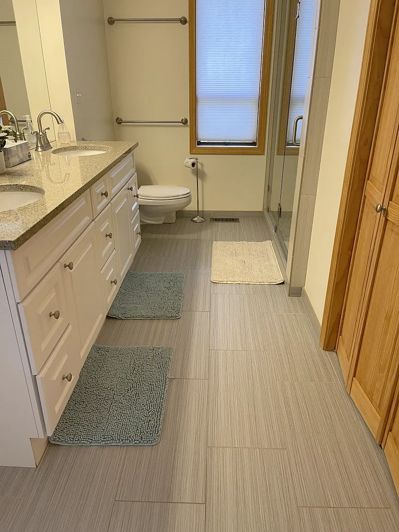 Bathroom with double vanity and tiled floor